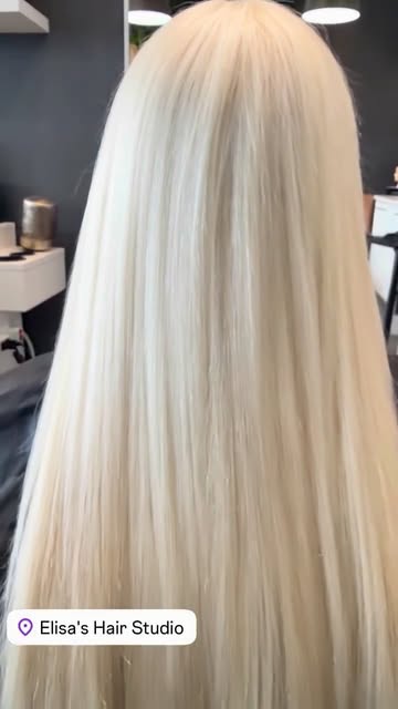 Long smooth platinum blonde hair created at Elisa’s Hair Studio